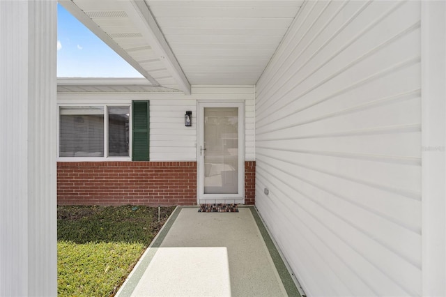 property entrance featuring brick siding