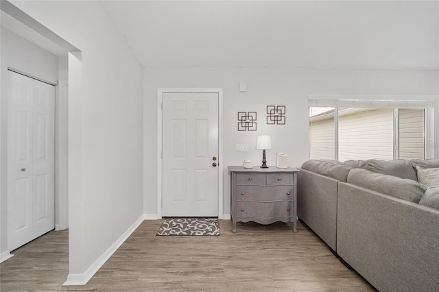 interior space with baseboards and light wood-style floors