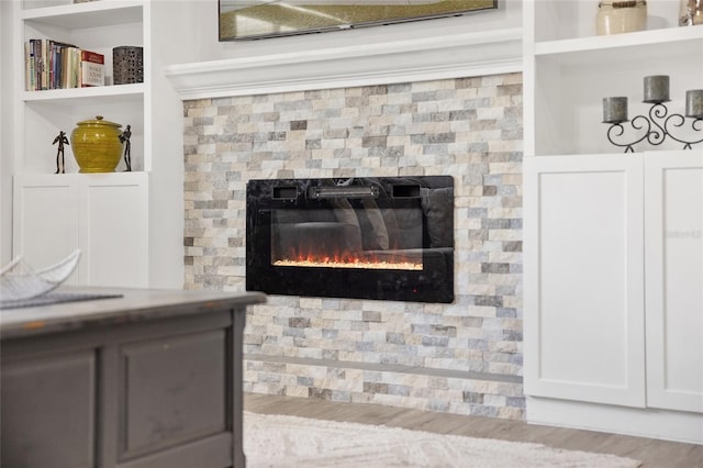 room details featuring a glass covered fireplace