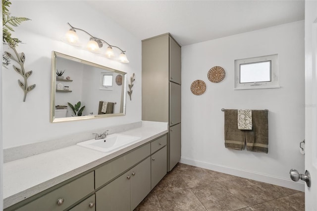 bathroom featuring tile patterned flooring, vanity, and baseboards