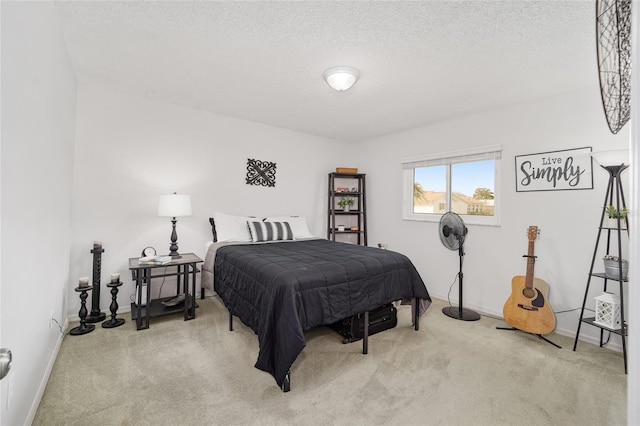 bedroom featuring a textured ceiling, carpet floors, and baseboards