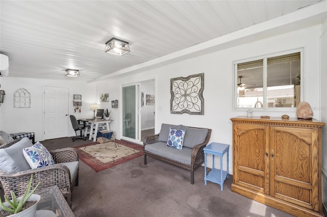 carpeted living room featuring an AC wall unit