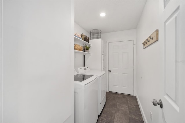 clothes washing area with laundry area, washer and clothes dryer, and baseboards