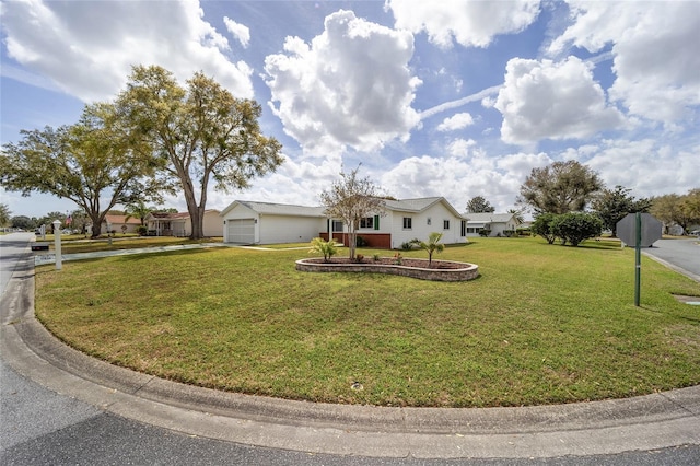 ranch-style home with a garage, concrete driveway, and a front lawn