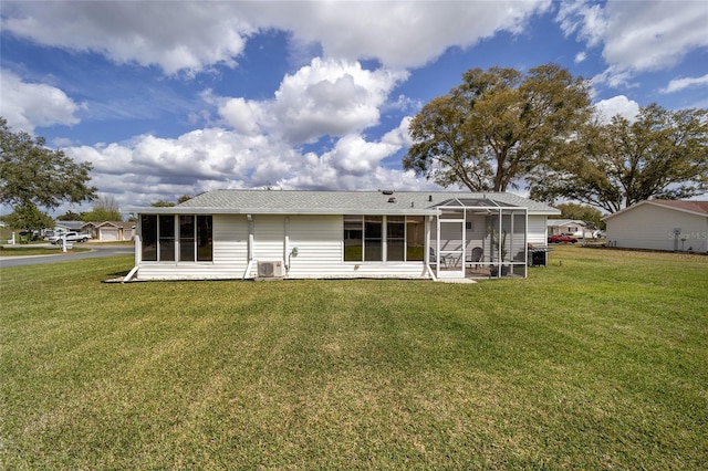 back of house featuring a yard, cooling unit, and a sunroom