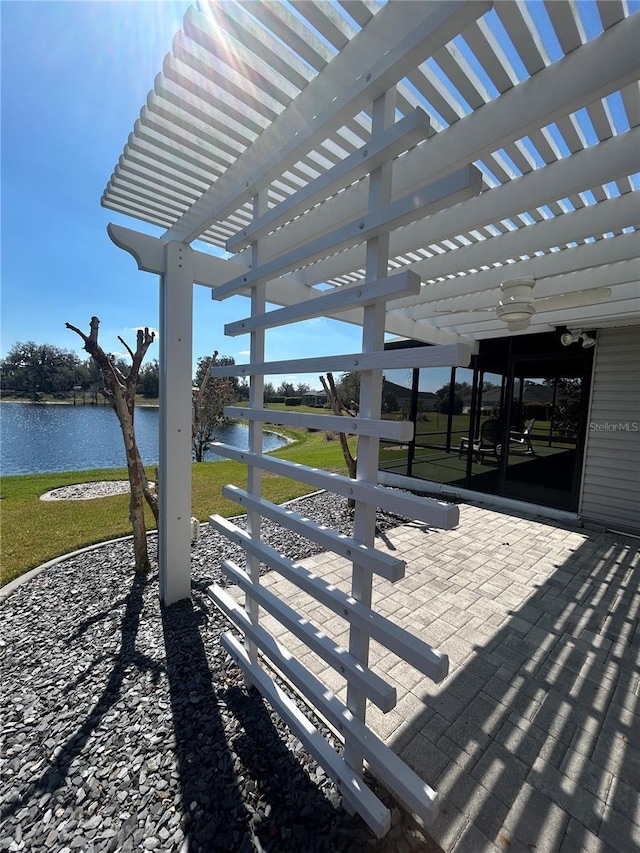 view of patio / terrace with a water view and a pergola