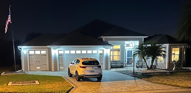 view of front facade featuring a garage and decorative driveway