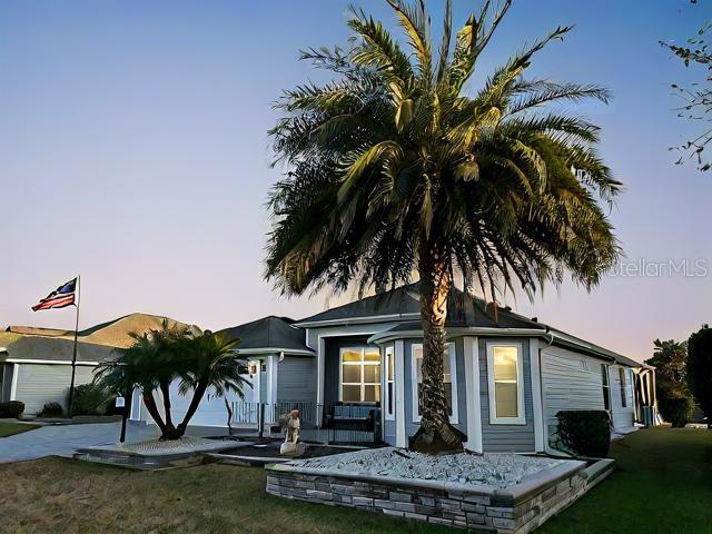 view of front of home with a garage, driveway, and a lawn