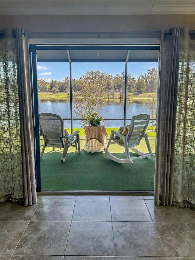 entryway featuring ornamental molding and a water view