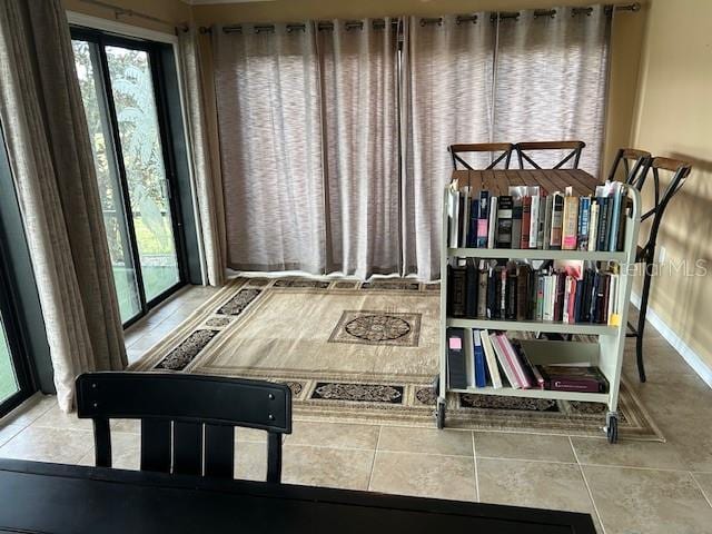 recreation room featuring tile patterned flooring and plenty of natural light