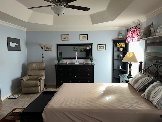 tiled bedroom featuring baseboards, a raised ceiling, a ceiling fan, and crown molding