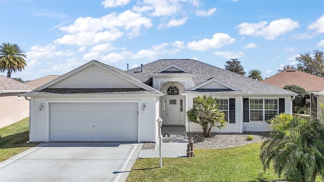 ranch-style house featuring a garage, driveway, a shingled roof, and a front yard