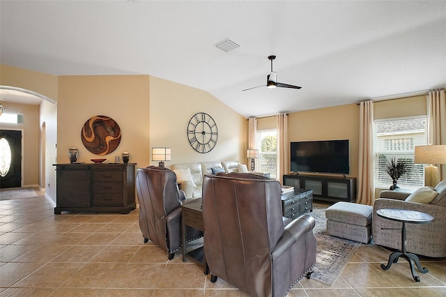 living room with arched walkways, plenty of natural light, lofted ceiling, and visible vents