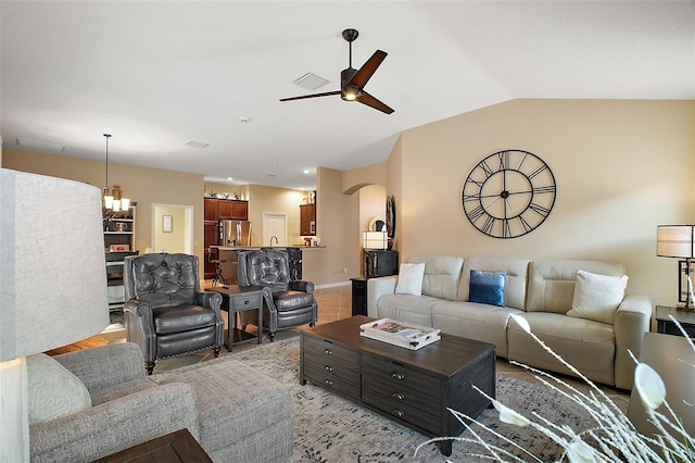 living room featuring arched walkways, ceiling fan, and lofted ceiling