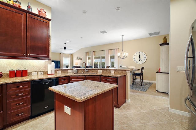 kitchen with dishwasher, tasteful backsplash, a sink, and reddish brown cabinets