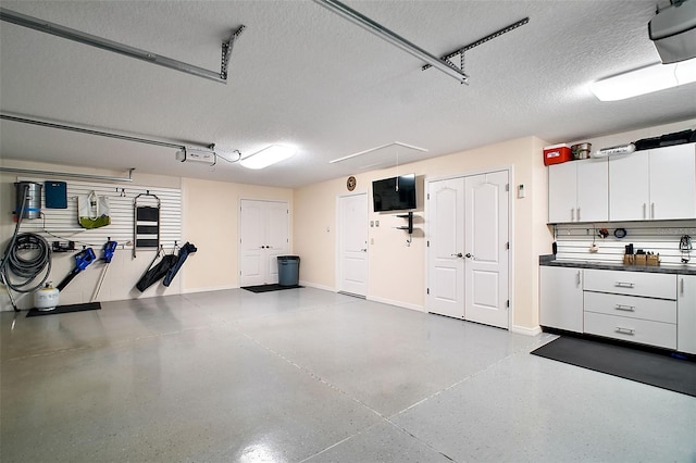 garage featuring baseboards and a garage door opener