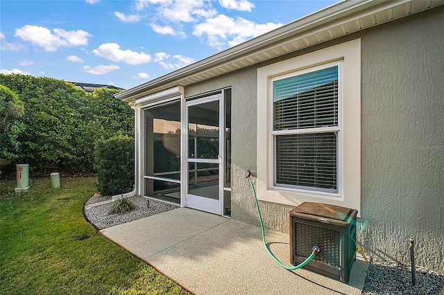 view of patio featuring a sunroom