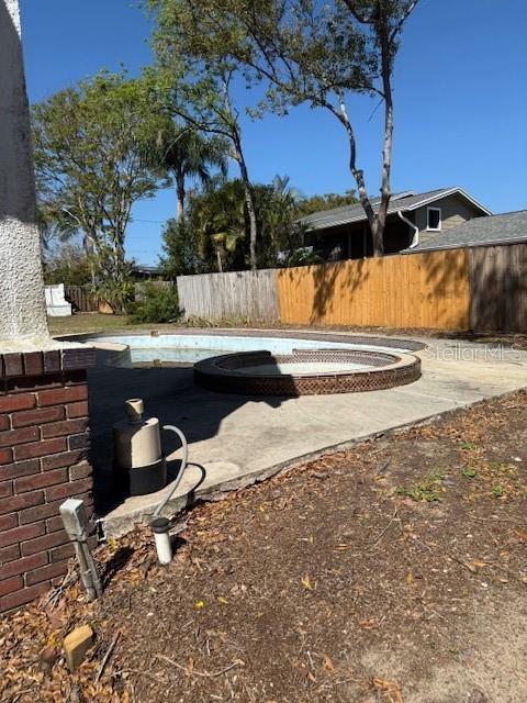 view of yard featuring a patio, fence, and a fenced in pool