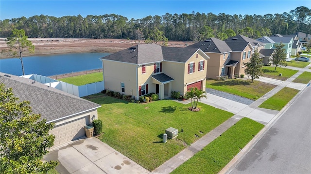 drone / aerial view with a water view and a residential view