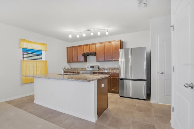 kitchen featuring light stone counters, stainless steel appliances, visible vents, a sink, and under cabinet range hood