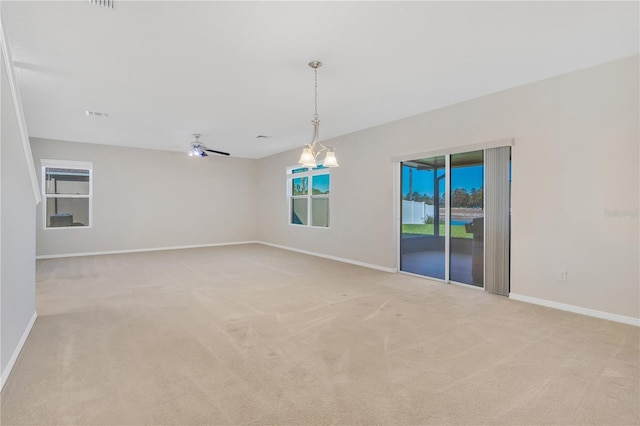 unfurnished room featuring a ceiling fan, light carpet, visible vents, and baseboards