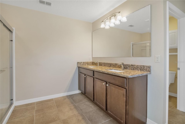 bathroom featuring visible vents, a sink, a shower stall, and baseboards