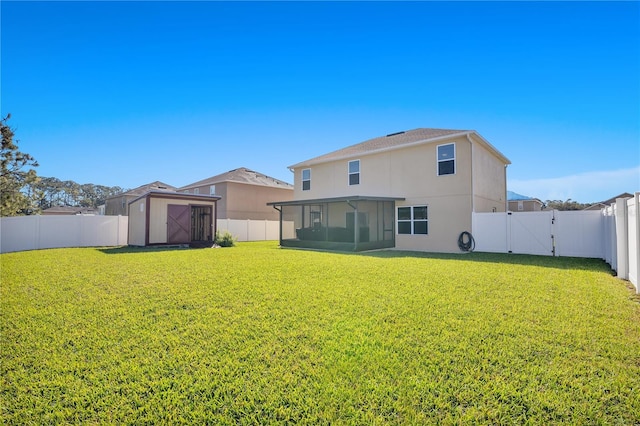 back of house with a sunroom, a fenced backyard, a gate, and a shed