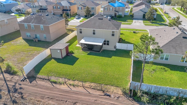 birds eye view of property with a residential view