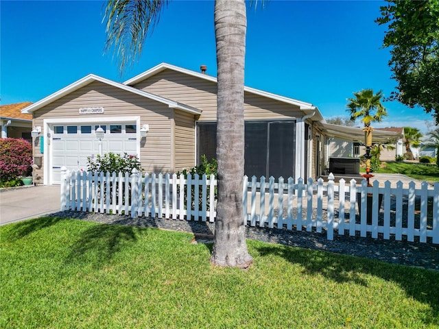 view of front of house featuring a garage, driveway, a fenced front yard, and a front yard