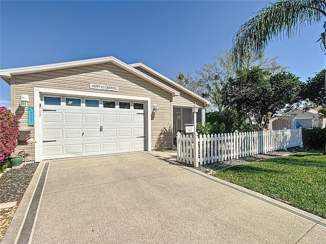 view of front of house with a garage, concrete driveway, and fence