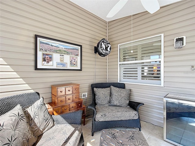 living area with a ceiling fan, wine cooler, and tile patterned flooring