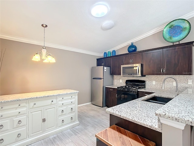 kitchen with pendant lighting, appliances with stainless steel finishes, ornamental molding, a sink, and dark brown cabinets