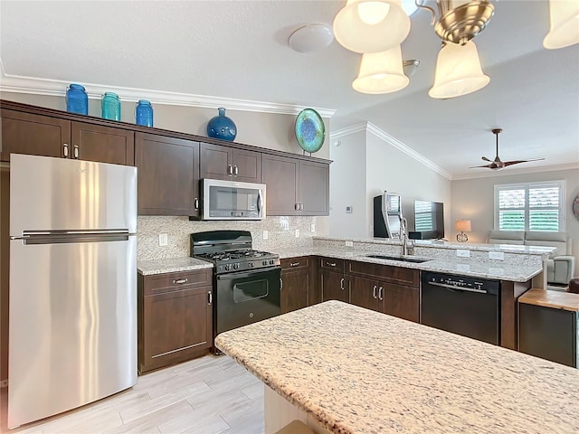 kitchen featuring dark brown cabinetry, ornamental molding, a peninsula, black appliances, and a sink