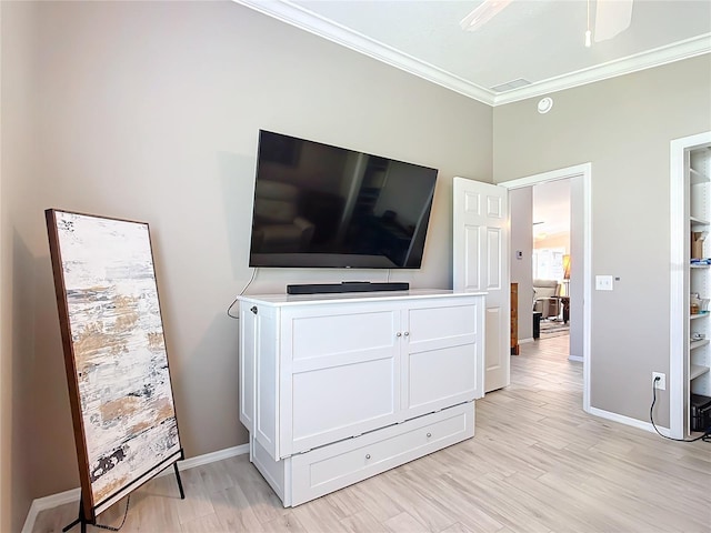 bedroom with light wood-type flooring, crown molding, and baseboards