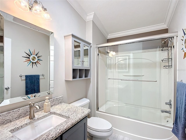 full bath featuring bath / shower combo with glass door, ornamental molding, vanity, and toilet