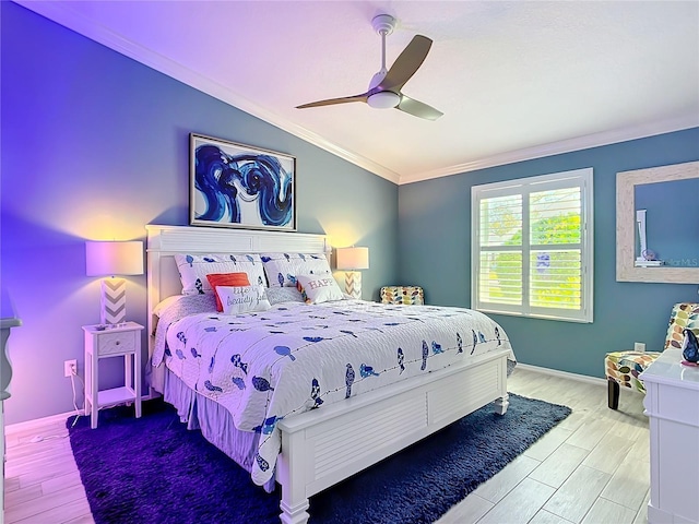 bedroom with crown molding, vaulted ceiling, ceiling fan, wood finished floors, and baseboards