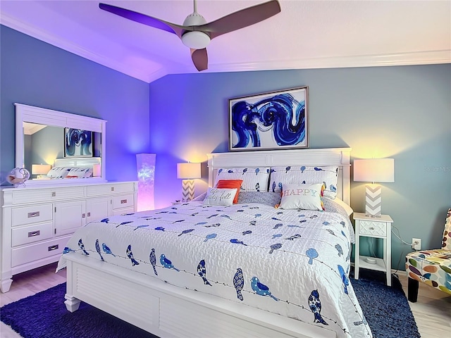 bedroom with wood finished floors, a ceiling fan, and baseboards