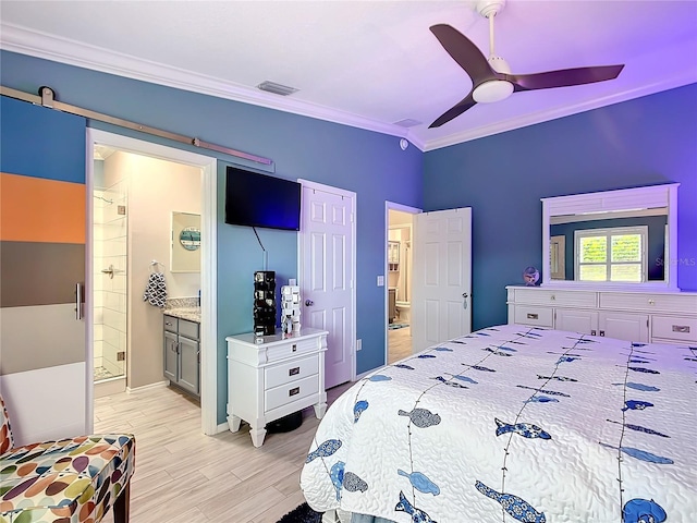 bedroom featuring light wood finished floors, visible vents, connected bathroom, and ornamental molding