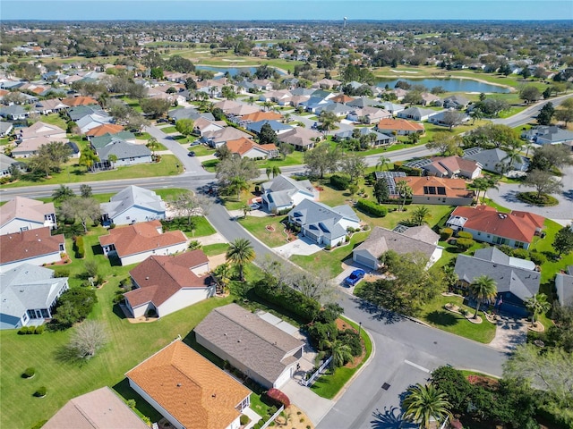 birds eye view of property with a water view and a residential view