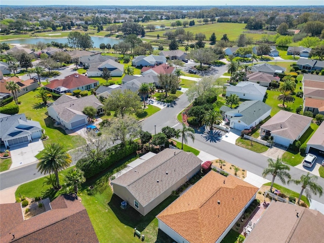 drone / aerial view featuring a water view and a residential view