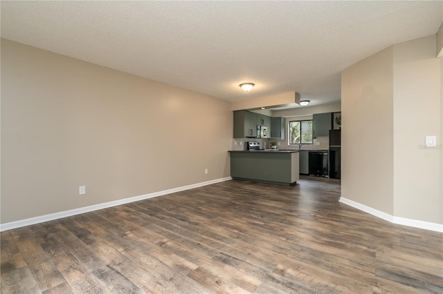 unfurnished living room featuring a textured ceiling, baseboards, and dark wood-style flooring