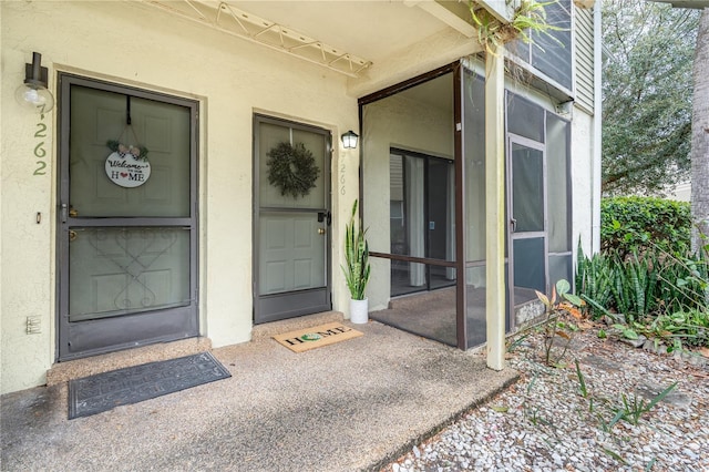 property entrance with stucco siding