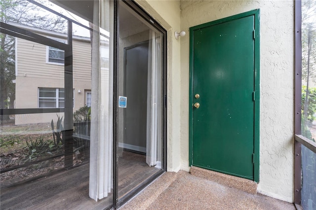 property entrance featuring stucco siding