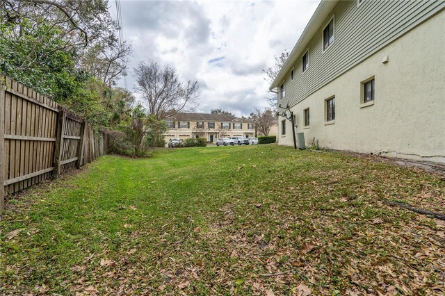 view of yard featuring a residential view and fence