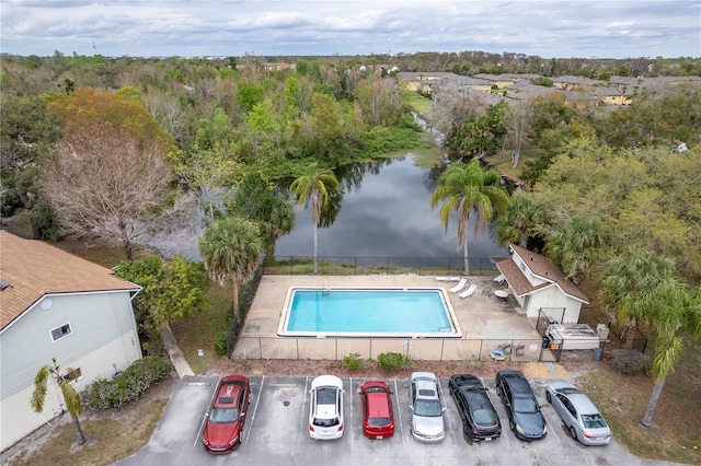 pool featuring a water view and fence