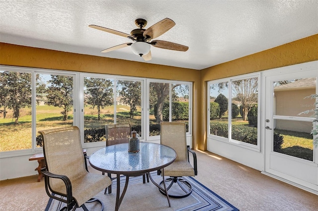 sunroom / solarium featuring ceiling fan