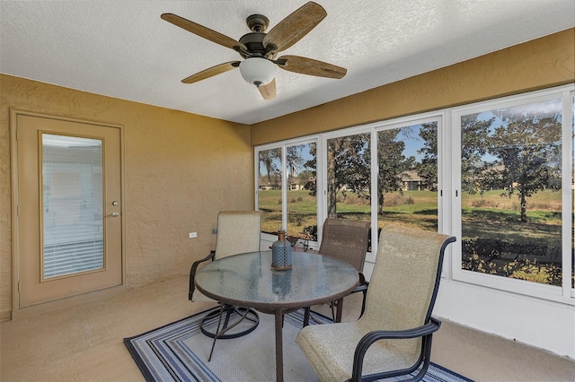 sunroom / solarium with a ceiling fan