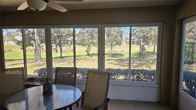 sunroom featuring ceiling fan