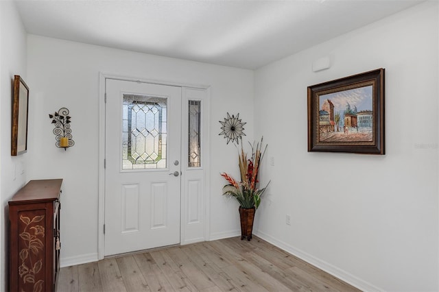 entrance foyer featuring light wood-style flooring and baseboards