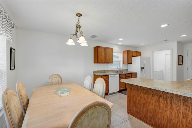 dining room featuring light tile patterned floors, visible vents, an inviting chandelier, a textured ceiling, and recessed lighting